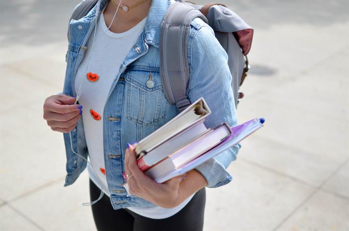 girl holding books